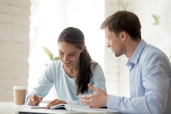 A man and a woman having a conversation at a table