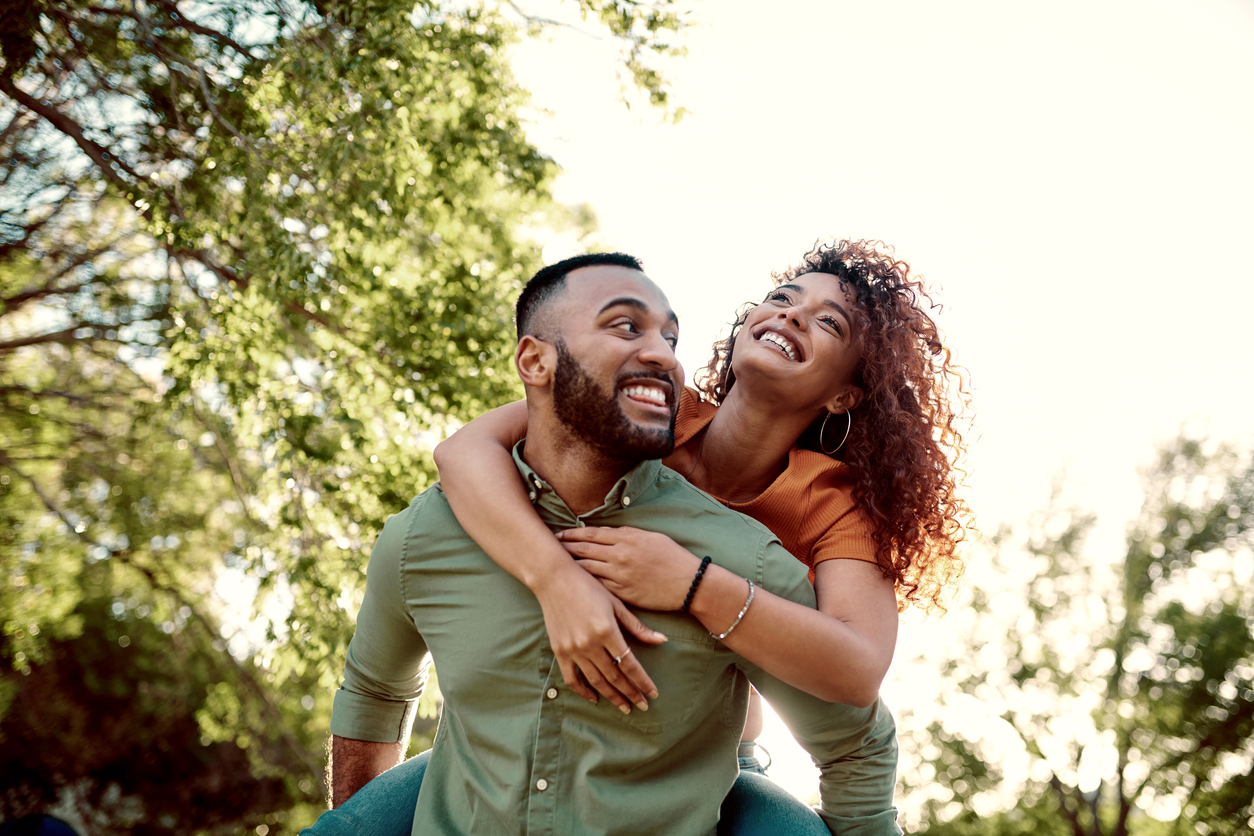 A young couple enjoying a walk in the park iStock-1300273437