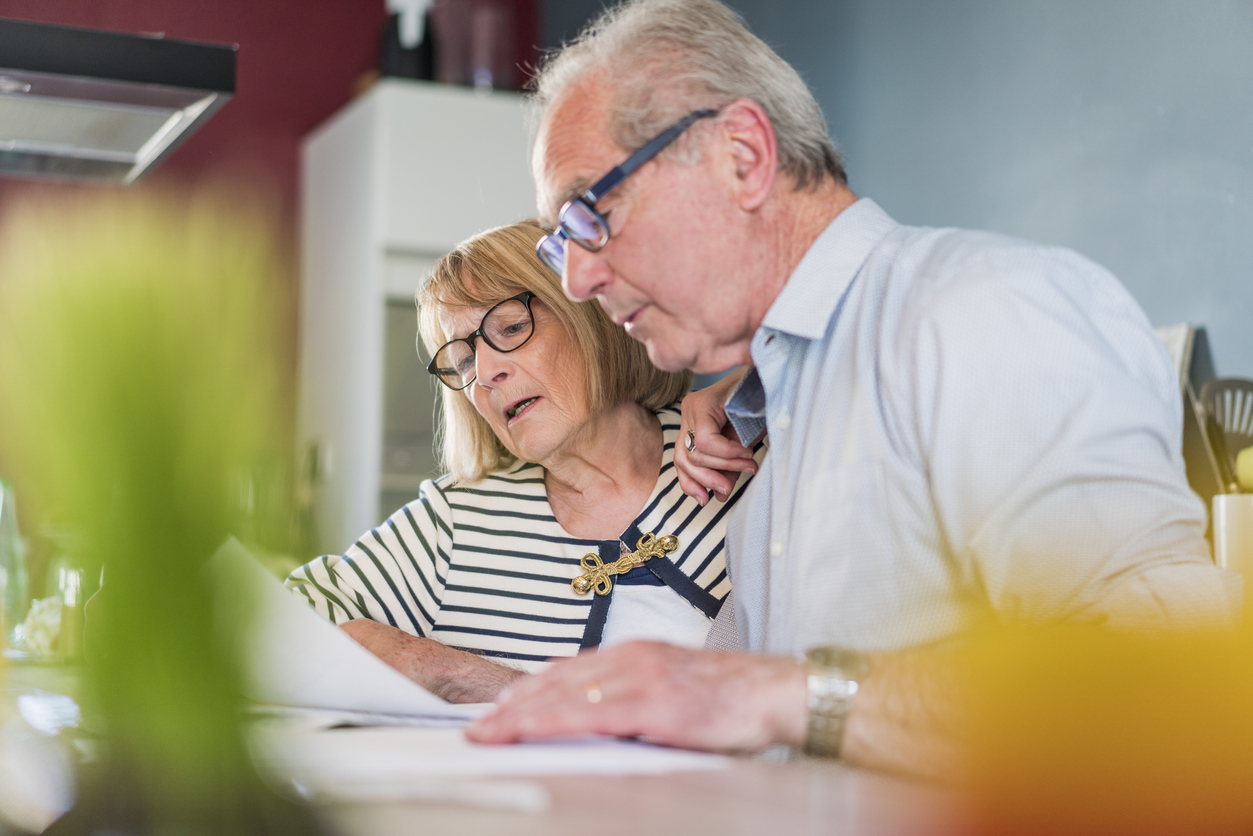 An elderly couple budgeting finances