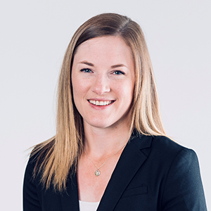 Megan Wassink headshot. She is wearing a dark blazer, and has long blonde hair.